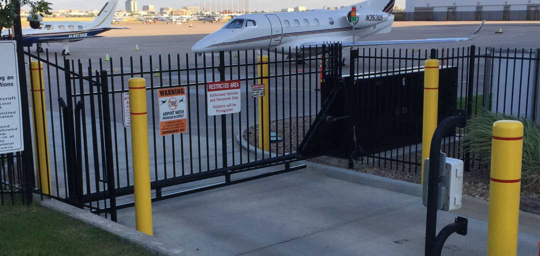 Airport security tilt gate installation by Accent Alarms with private jets in background